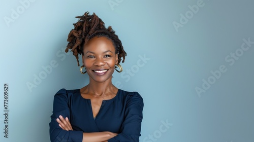 Closeup portrait of mid aged professional businesswoman, beautiful confident adult woman in navy top smiling isolated on blue background, copy space. photo