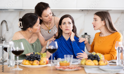 Woman shares her problems with her friends. They calm her down