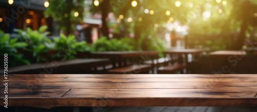 A wooden table is set in the warm ambiance of a cozy restaurant with a blurred background creating a welcoming atmosphere