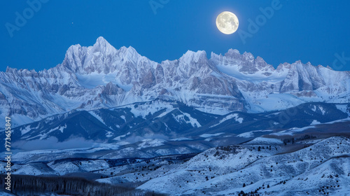 Natures own artwork as the moons shimmering light dances across the sharp peaks and valleys of the snowcovered mountain range. . .