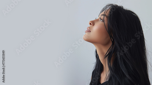 Malay woman wearing black criss cross dress smile isolated on gray photo
