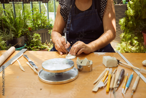 Pottery making, Female potter hands making a clay lotus at home 

