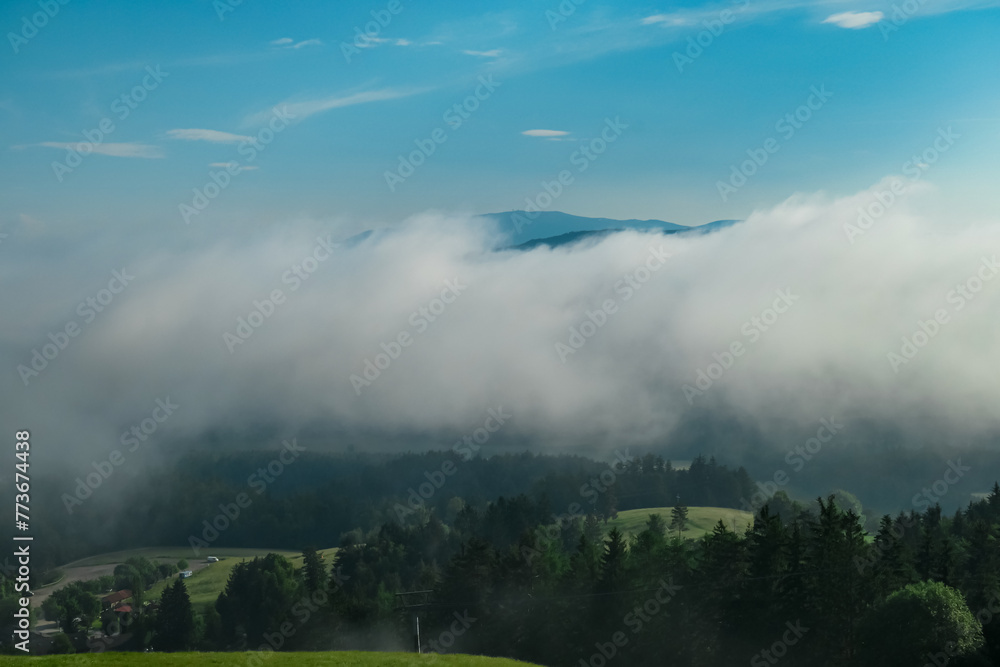 Scenic view of Jauntal valley covered by thick clouds seen from mountain resort Petzen, Bleiburg, Carinthia, Austria. Idyllic hiking trail in spring on alpine meadows in Austrian Alps. Wanderlust
