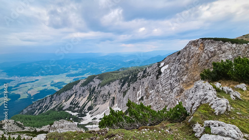 Panoramic view of mountain ridge Feistritzer Spitze (Hochpetzen), Carinthia, border Austria Slovenia. Alpine terrain of mountains Karawanks, Slovenian Austrian Alps. Hiking trail Petzen, Bleiburg photo