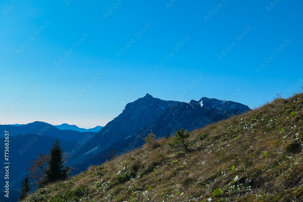 Panoramic view of majestic mountain peaks of Gesäuse seen from Hochblaser in Eisenerz Alps, Ennstal Alps, Styria, Austria. Idyllic hiking trail in remote Austrian Alps in summer. Wanderlust in nature