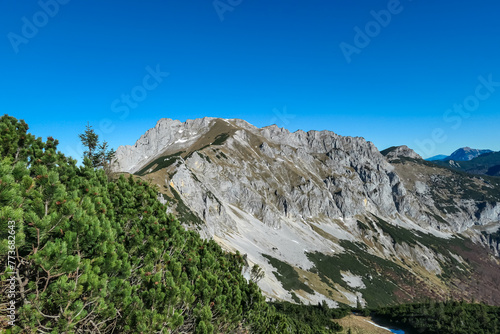 Panoramic view of majestic mountain peaks seen from Hochblaser in Eisenerz, Ennstal Alps, Styria, Austria. Looking at massive rock formation Kalte Mauer. Alpine landscape. Wanderlust concept in summer photo