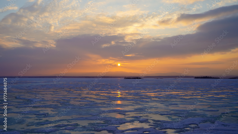 Beautiful panoramic view of the frozen lake at sunset. Beauty is in nature. Winter background.