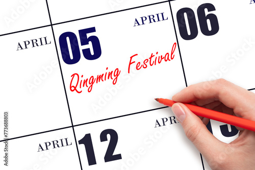 April 5. Hand writing text Qingming Festival  on calendar date. Save the date.