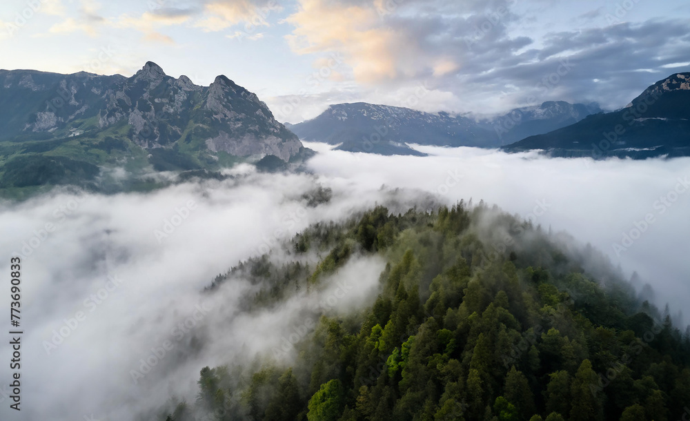 Misty Mountain Landscape with Clouds: A serene scene of fog veiling the majestic peaks, creating an ethereal atmosphere in this mountain landscape. Misty Mountain Landscape with Clouds: A serene scene of fog veiling the majestic peaks, creating an ethereal atmosphere in this mountain landscape.
