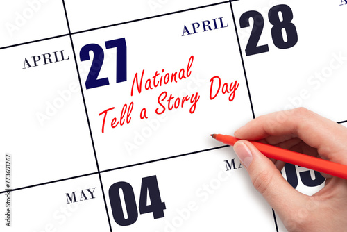 April 27.  Hand writing text National Tell a Story Day on calendar date. Save the date. © Alena