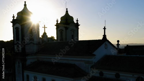 Aerial view of Nosso Senhor do Bonfim church back side, the neighbourhood and the ocean at background, at sunset, Salvador, Bahia, Brazil photo