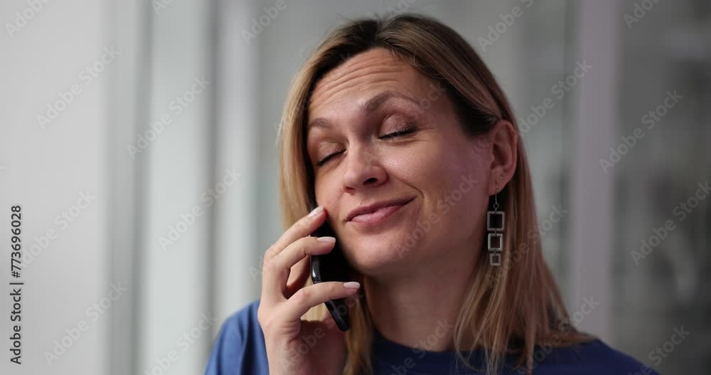 Smiling woman is tired and talking on the phone Smiling woman is tired and talking on the phone