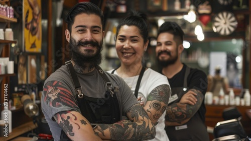 Tattooed barbers smiling with pride in their shop. Three tattooed and smiling barbers stand confidently in their stylish barbershop