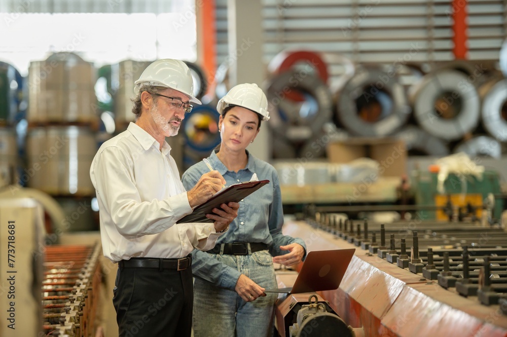 Two professional technician engineer worker use clipboard checking operating equipment machine monitors and check Production process machinery. Two engineer confederate control factory machine Two professional technician engineer worker use clipboard checking operating equipment machine monitors and check Production process machinery. Two engineer confederate control factory machine