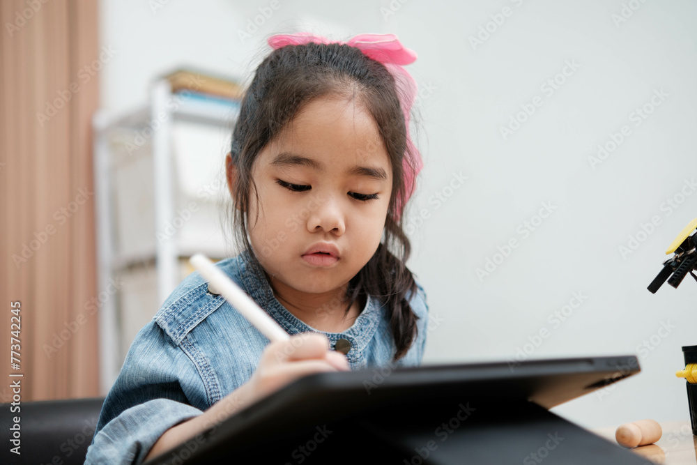Young Girl Drawing on Digital Tablet with Stylus Pen Young Girl Drawing on Digital Tablet with Stylus Pen