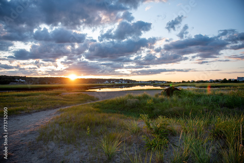 Sunset over marsh with low clouds on a summer night. © Cavan