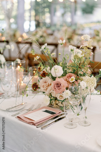 Chic wedding reception table with floral centerpiece