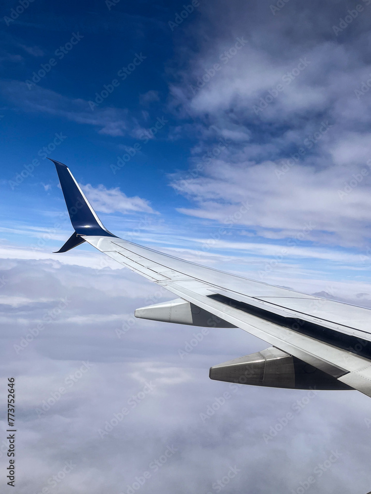 Wing of an airplane in the blue sky Wing of an airplane in the blue sky