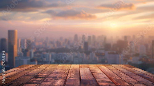 A serene Scene of sunset hues washing over a cityscape, as seen from a rich wooden surface photo