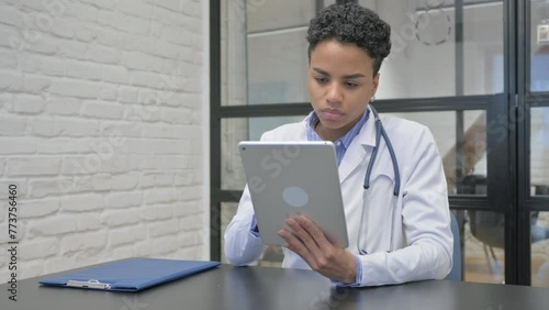 African Female Doctor Working on Digital Tablet photo