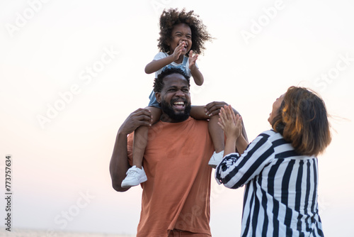 Portrait of enjoy happy love black family.play, having fun, daughter, parenthood, care, superhero.african american father and mother with little african girl child smiling moments good time at home