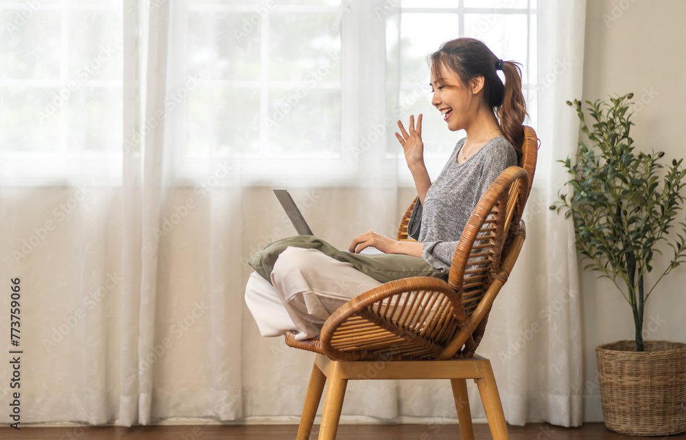 Young smiling asian woman relax using laptop conference work,learning education,study online,webinar podcast,creative woman looking at screen, shopping, online marketing at home Young smiling asian woman relax using laptop conference work,learning education,study online,webinar podcast,creative woman looking at screen, shopping, online marketing at home
