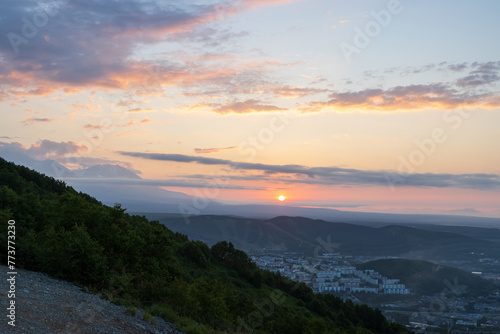 Beautiful morning cityscape. Residential urban areas at sunrise. Buildings among the hills. The sun rises over the mountains. City of Petropavlovsk-Kamchatsky, Kamchatka Krai, Far East of Russia. © Andrei Stepanov