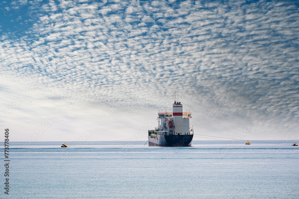 Oil chemical tanker anchored in the Mediterranean sea on a cloudy day