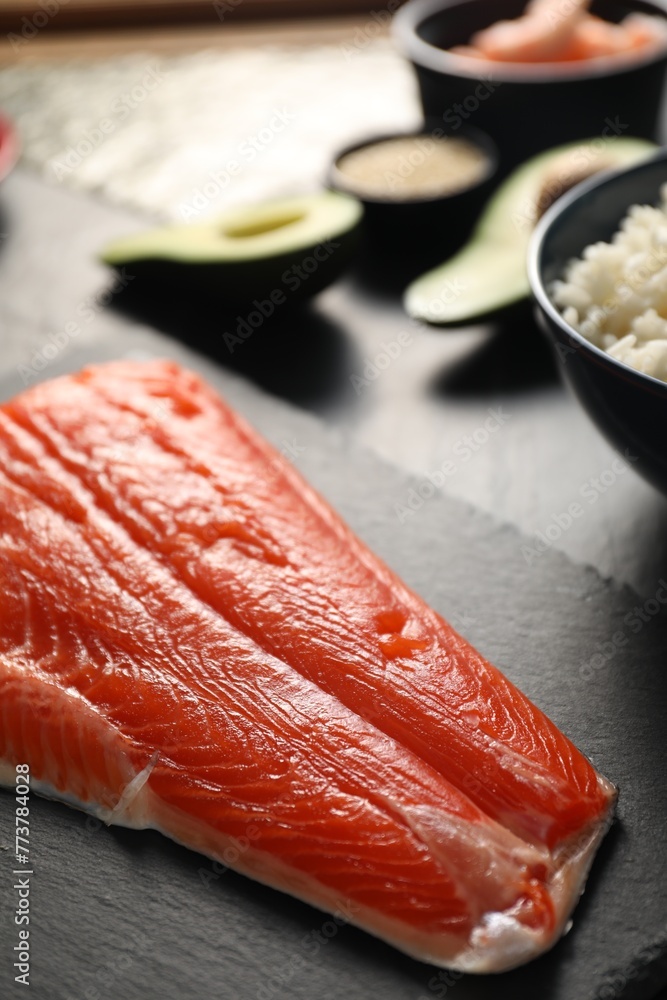 Fresh salmon for sushi on dark table, closeup Fresh salmon for sushi on dark table, closeup