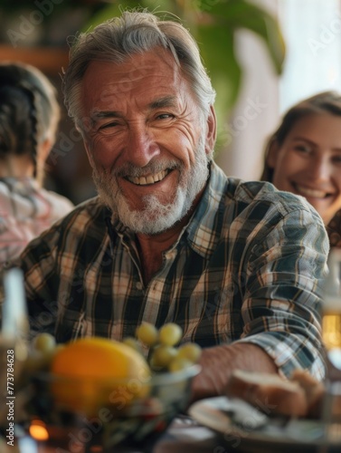 A man with a beard and gray hair is smiling at the camera