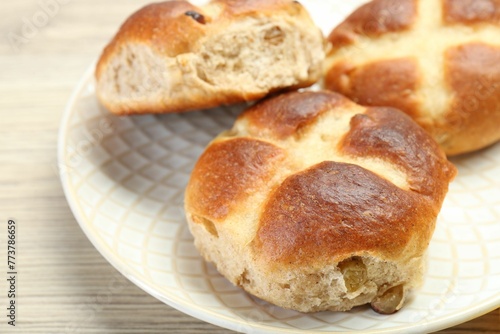 Hot cross buns on wooden table, closeup