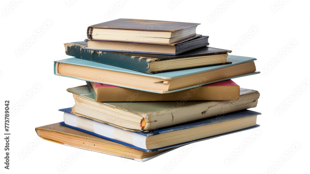 A tall stack of colorful books piled on top of each other A tall stack of colorful books piled on top of each other