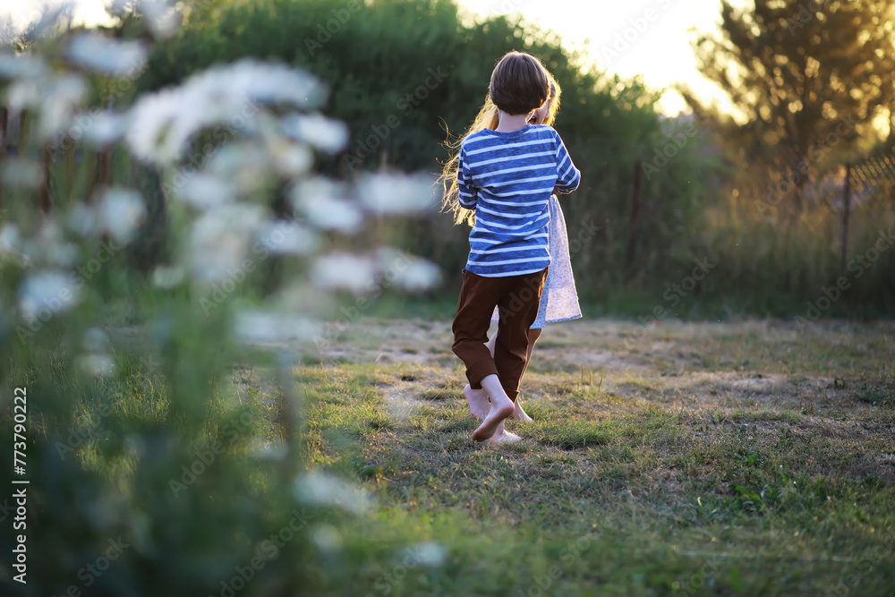 Children walk in the summer in nature. Child on a sunny spring morning in the park. Traveling with children. Children walk in the summer in nature. Child on a sunny spring morning in the park. Traveling with children.