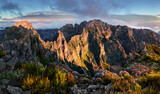 Mountain landscape at sunset in Madeira. Amazing view on colorful clouds and layered mountains.