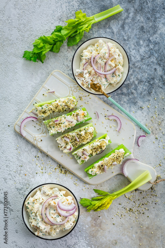 Celery sticks filled with egg and tuna salad, healthy vegetable snack