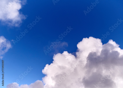 White cumulus clouds in the deep blue summer sky. Fluffy clouds background © Studio-M