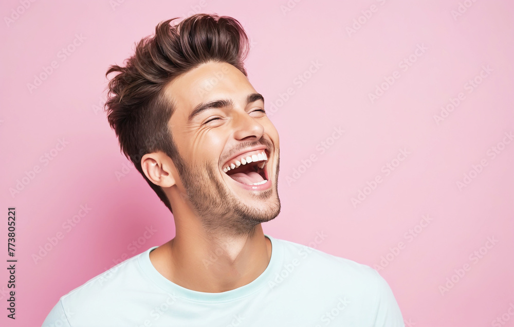 Handsome young man laughing on pastel background Handsome young man laughing on pastel background