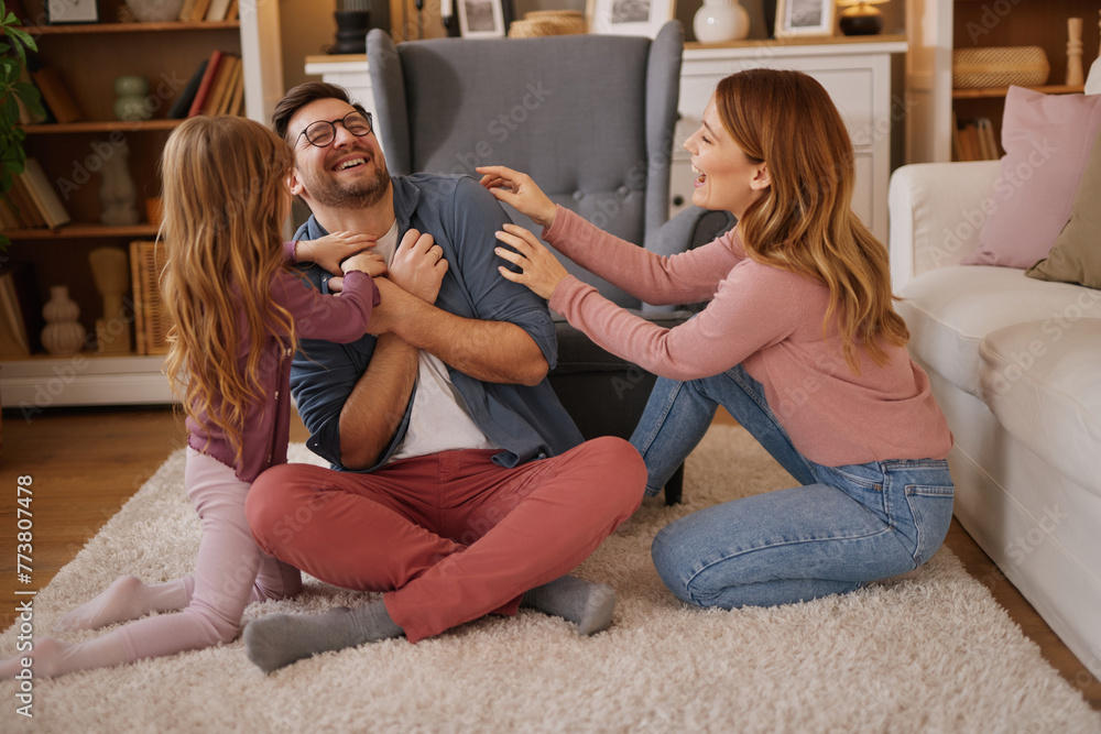 Parents having fun with their little daughter at home Parents having fun with their little daughter at home