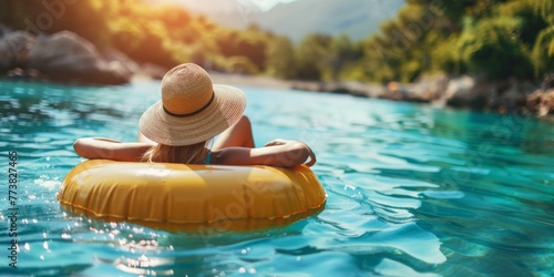 Summer vacation woman in hat floats on an inflatable donut mattress. Happy woman relaxing and enjoying family summer travel holidays travel © Svitlana