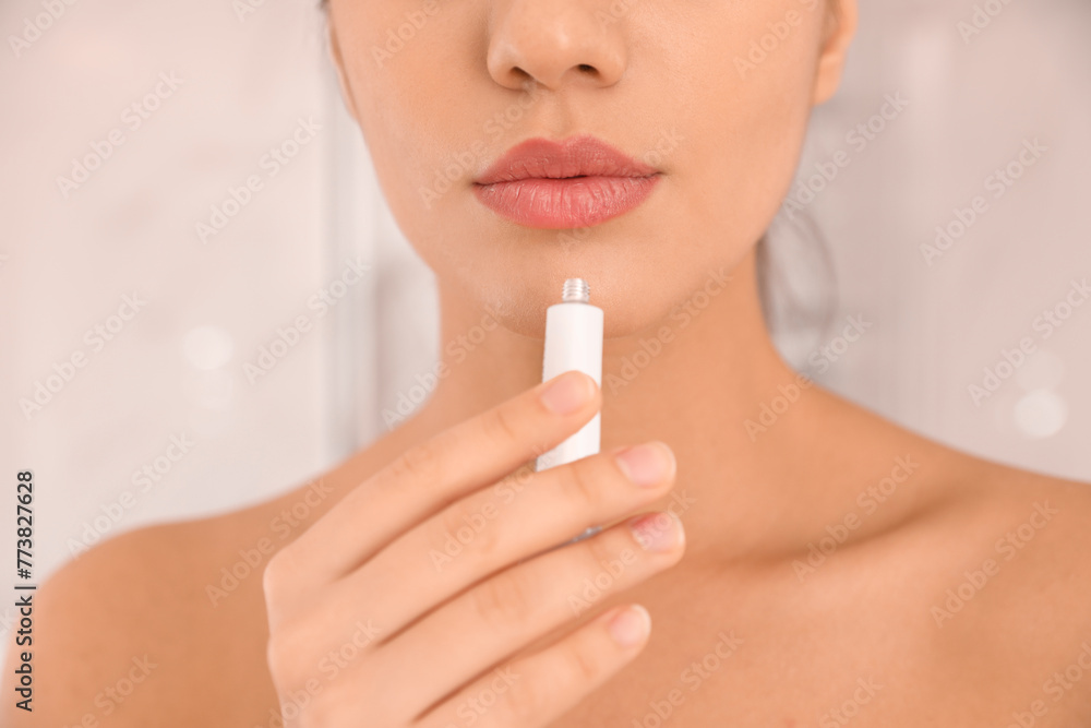 Woman with herpes applying cream on lips against blurred background, closeup Woman with herpes applying cream on lips against blurred background, closeup