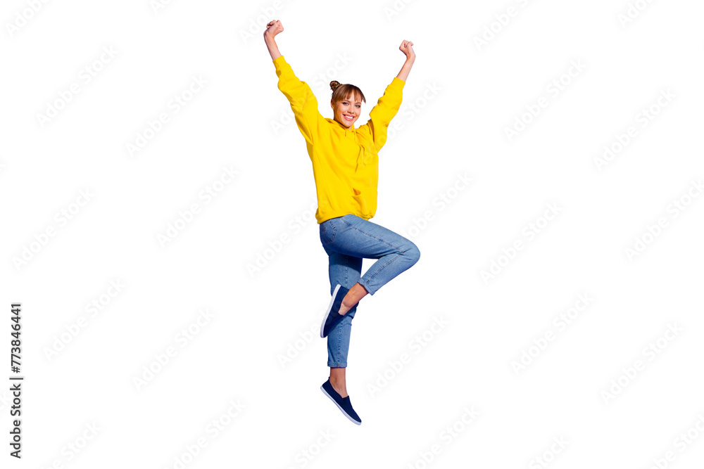 Full length body size photo of jumping high crazy cheer she her lady with pretty buns hairdo hands raised great big win wearing casual jeans yellow pullover isolated on purple background