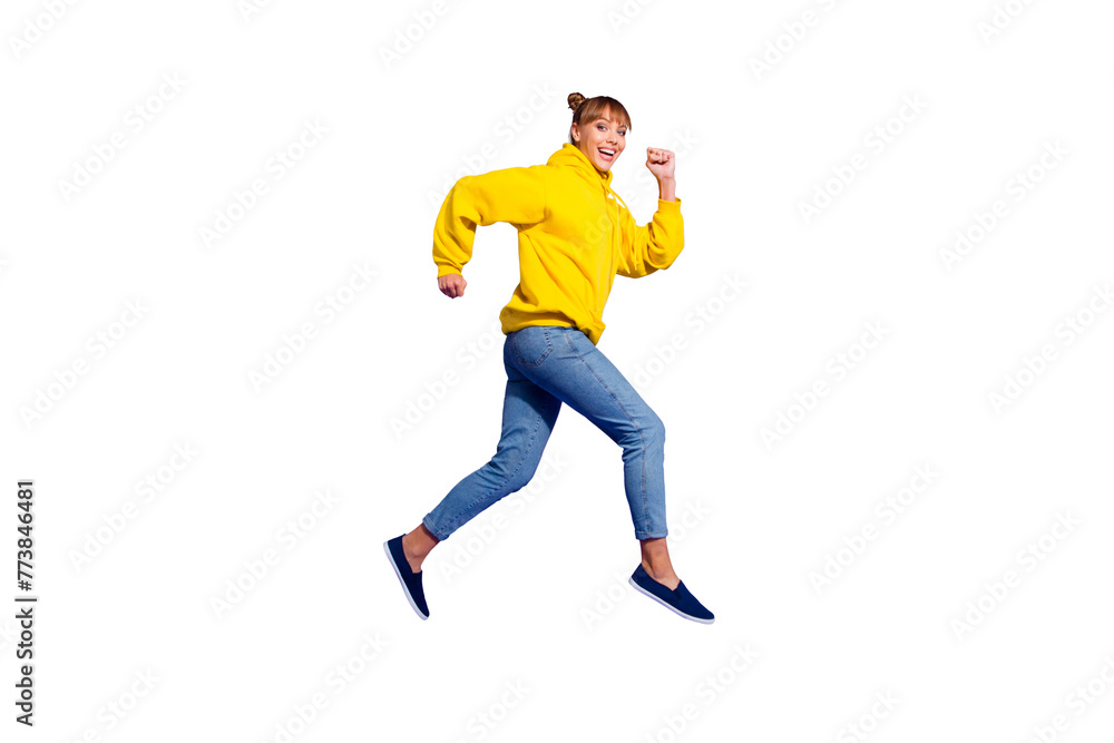 Full length body size photo of jumping high crazy cheer she her lady with pretty buns hairdo pretending jogging sportive wearing casual jeans yellow pullover isolated on purple background