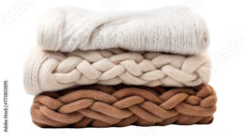 Three different colored blankets stacked neatly on top of each other