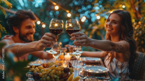 Couple Toasting Wine Glasses at Dinner Table