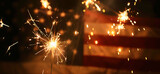 Fourth of July sparklers, independence celebration concept. Blurred stars and stripes.