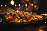 Assorted grilled meat and vegetable skewers on grill at outdoor barbecue party