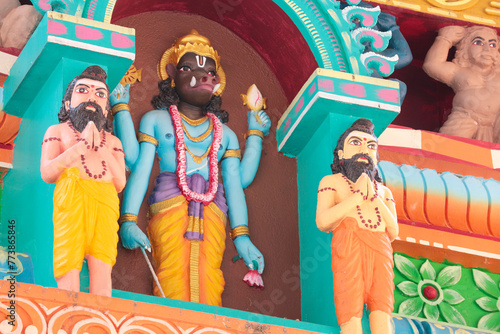 Varaha, embodiment of Vishnu avatar on the wall of a Hindu temple and Rishi sages.