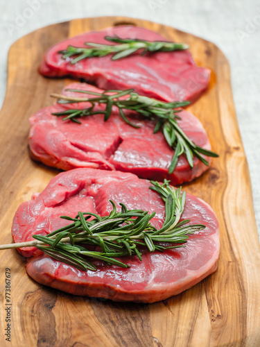 Fresh juicy boneless lamb steak on a wooden board. Premium meat product for cooking. High quality meat cut. Food chain.