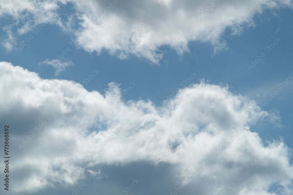 Clouds in the blue sky on a sunny day. Sunny sky background Clouds in the blue sky on a sunny day. Sunny sky background