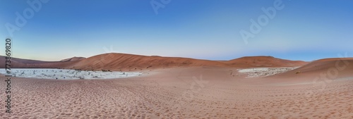 Panoramic view from the Big Daddy Dune in Sussusvlei onto the salt pan of Deathvlei with surrounding red dunes in the morning photo